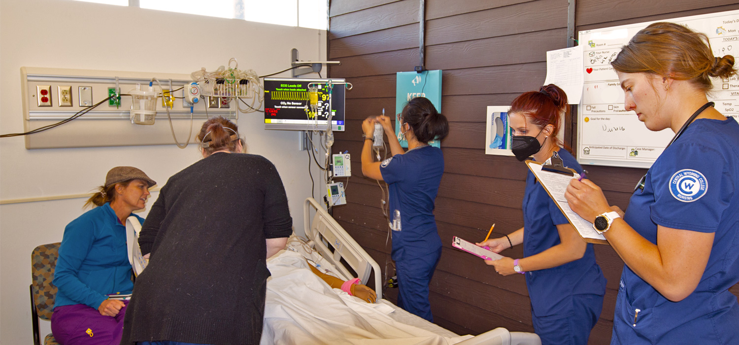 Nursing students working with a patient