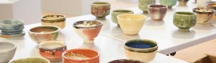 A wide variety of colorful ceramic bowls on top of a table