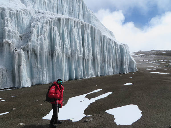 CWC student walking next to a glacier on Mount Kilimanjaro