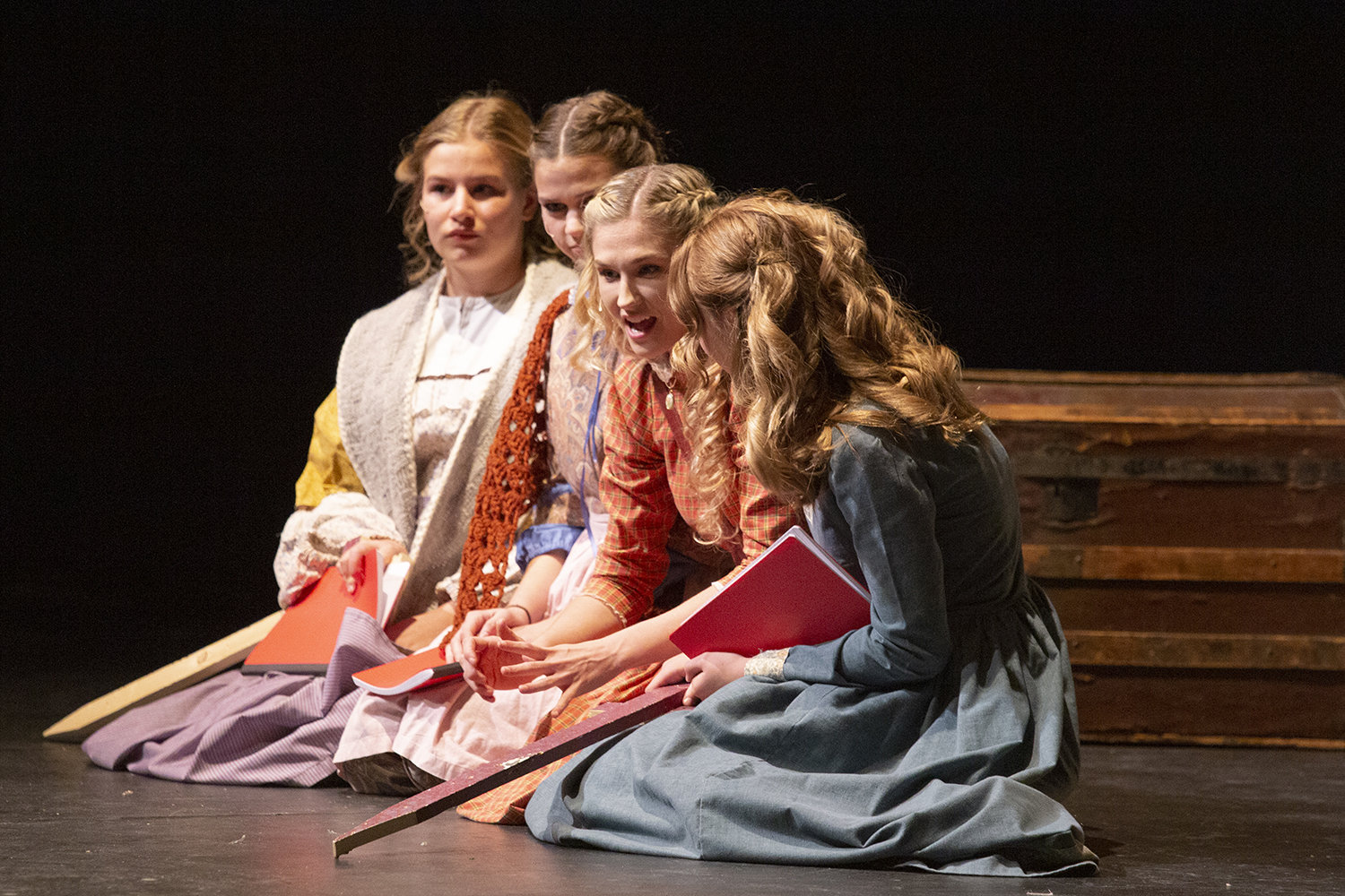 The cast of Little Women performs the parts of Jo, Meg, Amy, and Beth. 