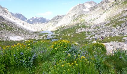 Two backpackers hike in the Wind River Mountains.