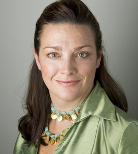 A headshot of Jennifer Marshall. She is wearing a green jacket & has brown hair