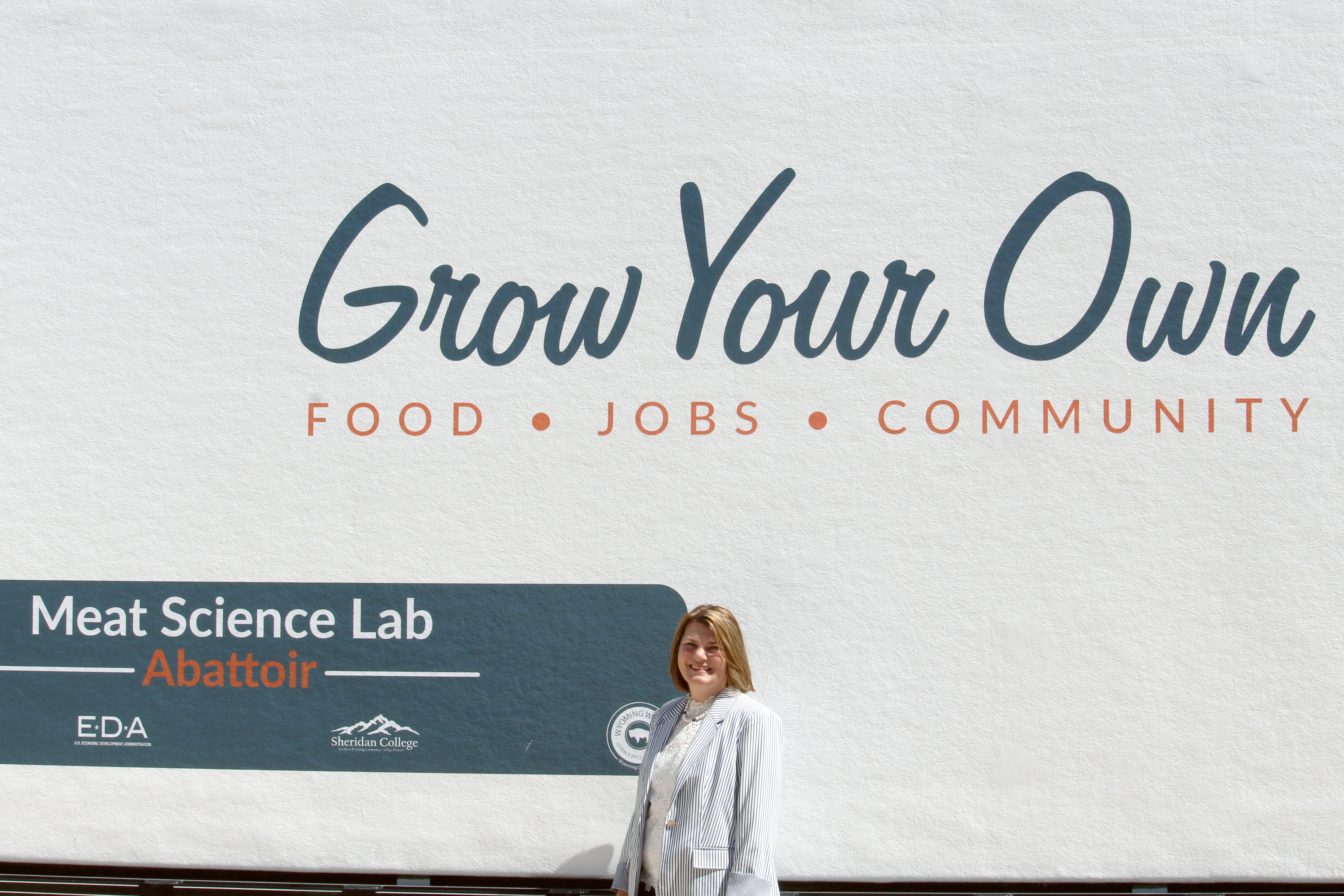 Jennie Gordon stands in front of CWC's mobile meat science lab