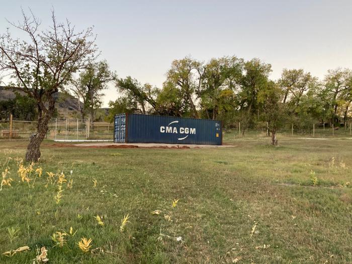 a shipping container in the field at the Alpine Science Institute