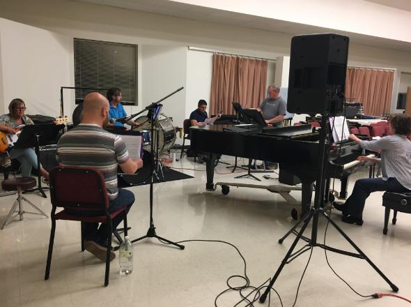 the orchestra of the retail song cycle sits in the music rehearsal room at CWC