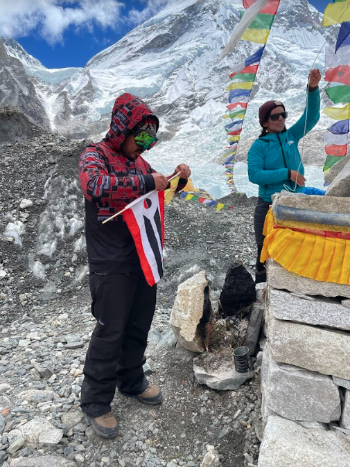 CWC Student attaching a prayer flag on Mount Everest Summit