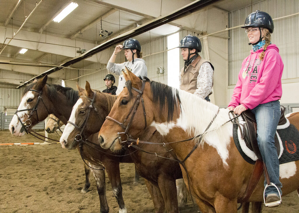 Students on their horses in the equine center