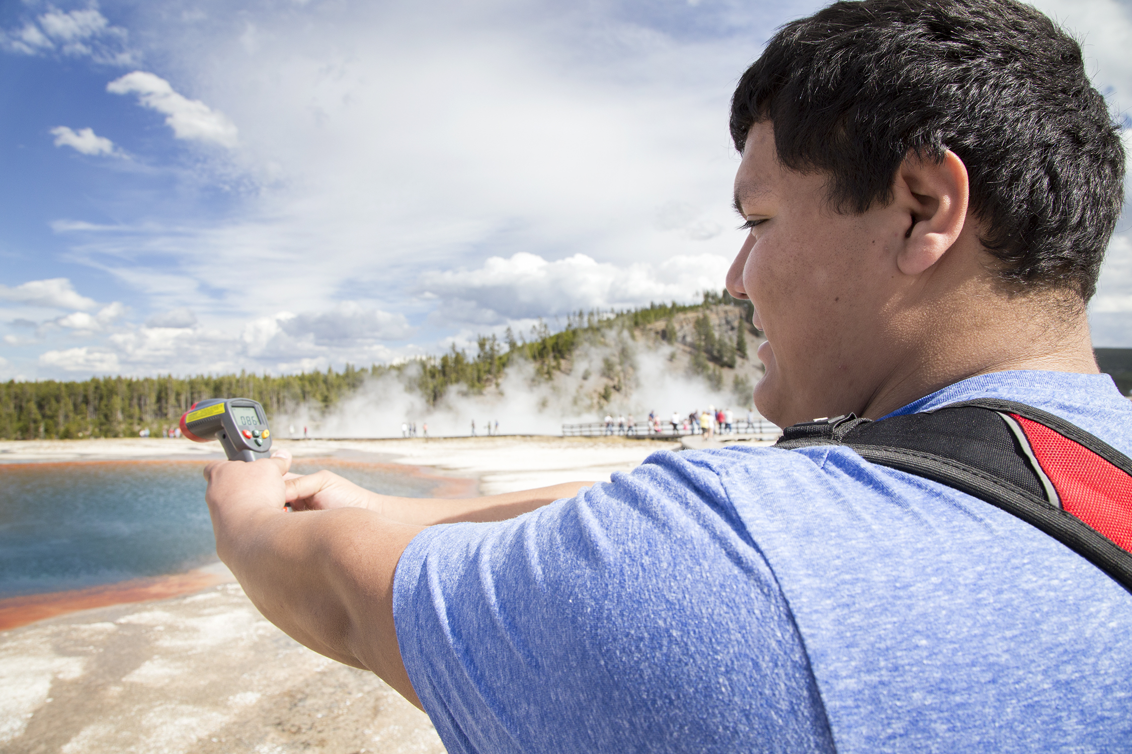 Jose Gonzalez captures the temperature of a hot spring in Yellowstone on a field trip with Professor Suki Smaglik. 