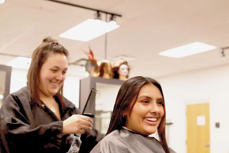 Amya Whelan and fellow cosmetology student Jenna DeClue. Photo by Sarah Elmquist Squires